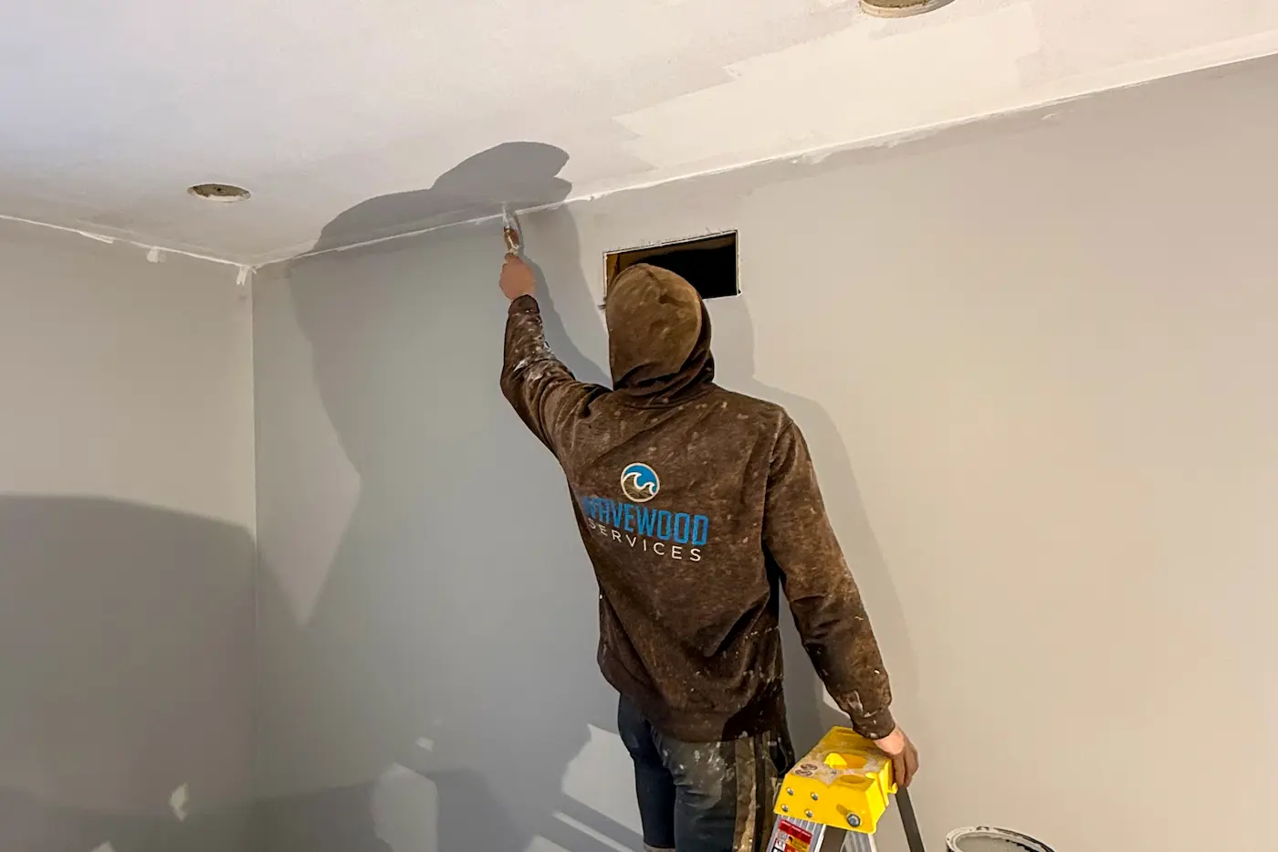 professional painter preparing ceiling for painting