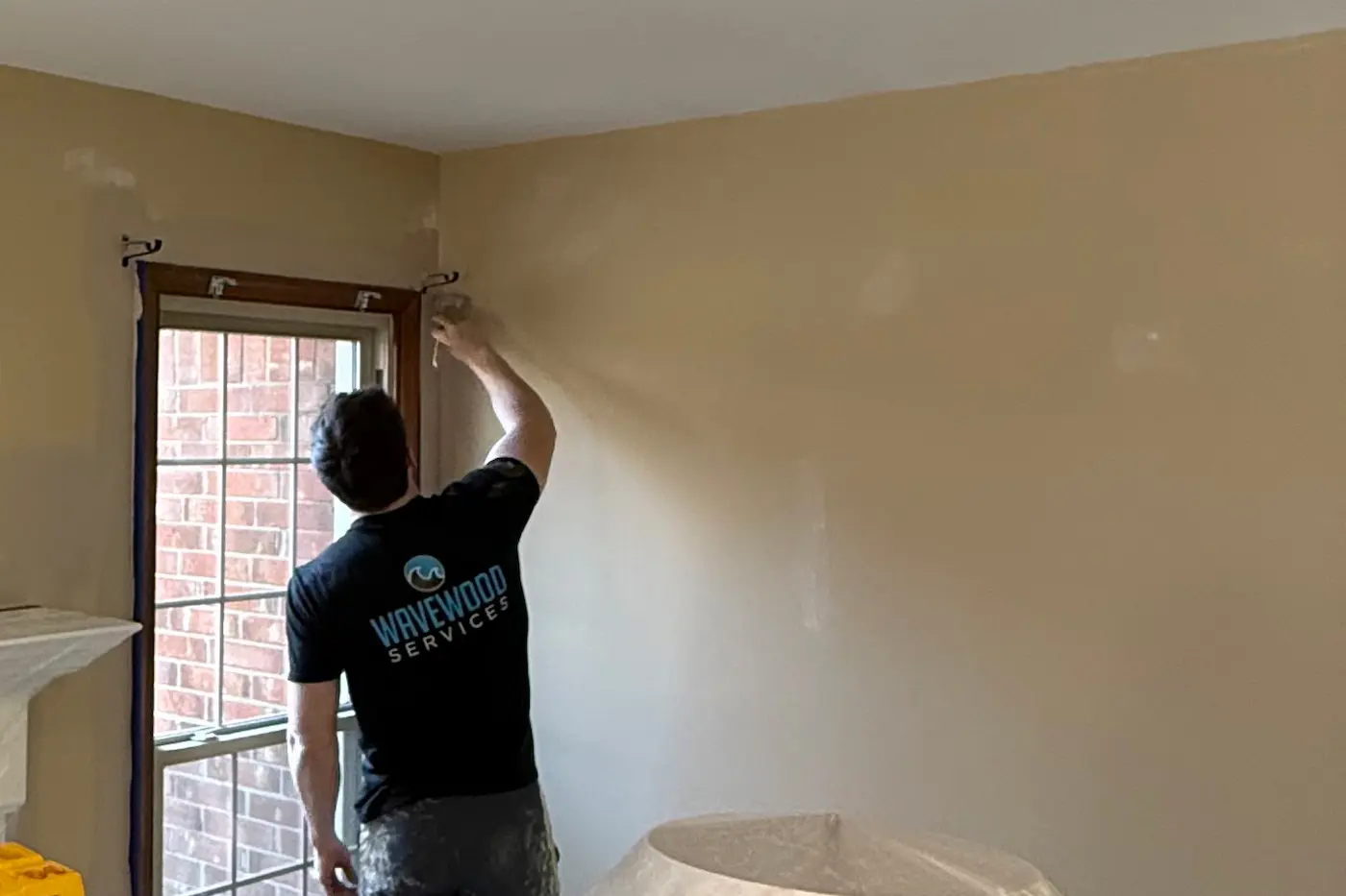 man painting trim