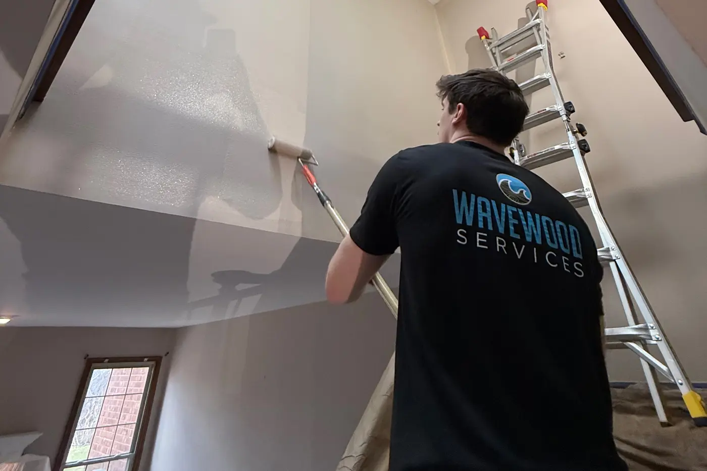 professional painter with wall roller